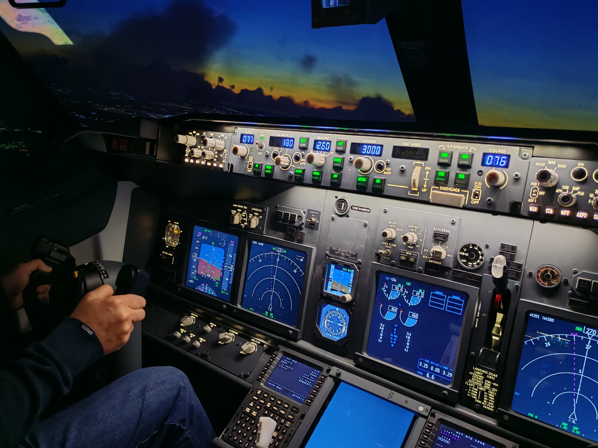 Hand on the control column, MCP glowing above, a dramatic dusk sky ahead
